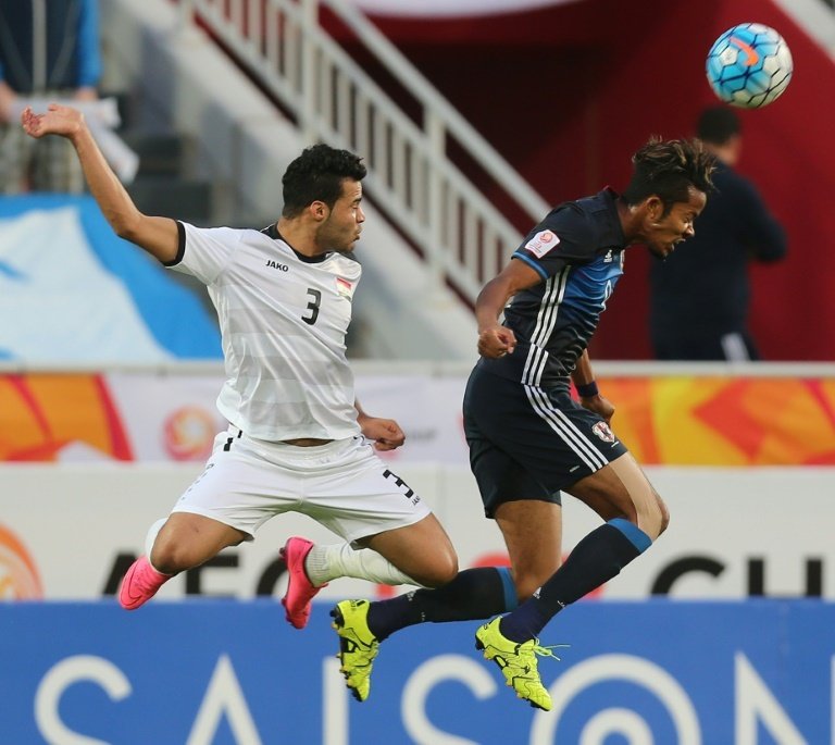 Iraqs defender Hamzah Adnan Lafloof and Japans forward Musashi Suzuki jump to head the ball during their AFC U23 Championship semi-final football match between Iraq and Japan in Doha on January 26, 2016