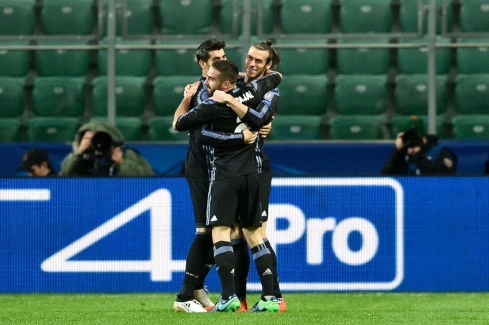 Real Madrid players celebrate after Gareth Bale (R) scored against Legia Warsaw. AFP