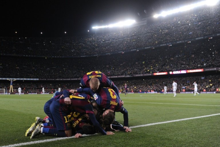 Barcelonas Uruguayan forward Luis Suarez is congratulated by his teammates after scoring during the clasico Spanish league football match FC Barcelona vs Real Madrid CF at the Camp Nou stadium in Barcelona on March 22, 2015
