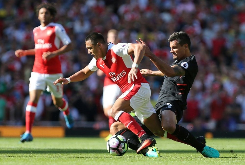 Arsenal's striker Alexis Sanchez () is tackled by Liverpool's defender Dejan Lovren. AFP