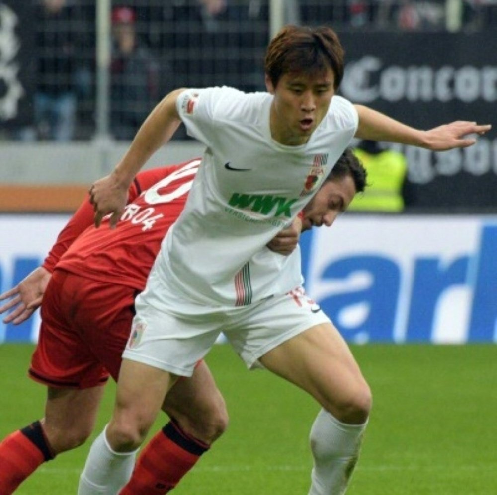 FC Augsburgs Koo Ja-Cheol and Leverkusens Tin Jedvaj vie for the ball on March 5, 2016 in the WWK-Arena, Augsburg, southern Germany