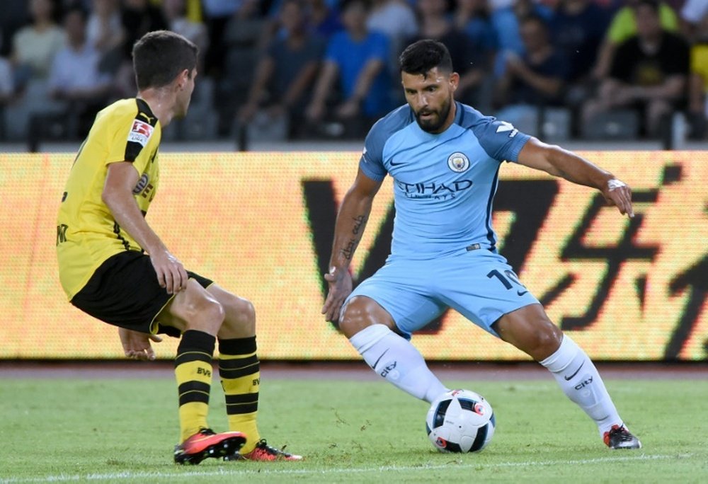 Manchester Citys Sergio Aguero (R) controls the ball during the 2016 International Champions Cup match against Borussia Dortmund in Shenzhen, on July 28, 2016