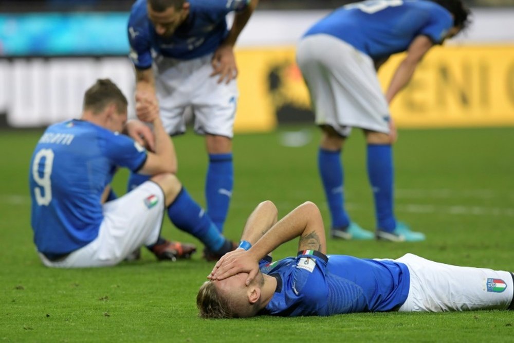 Italian footballers react after being held to a draw by Sweden. AFP