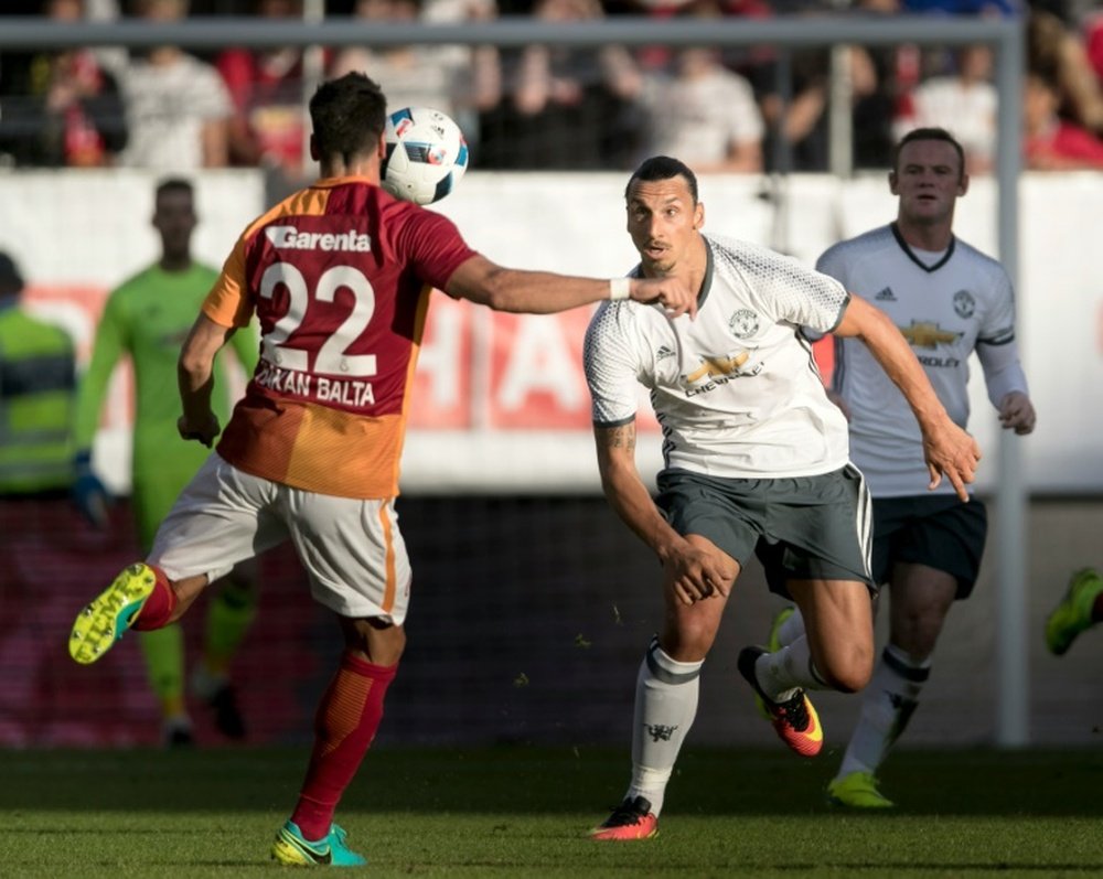 Galatasarays Hakan Balta controls the ball in front of Manchester Uniteds Zlatan Ibrahimovic during the Galatasaray v Manchester United pre-season friendly football match on Ullevi Stadium, Goteborg on July 30, 2016