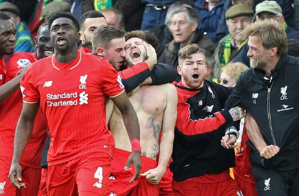Liverpools Adam Lallana (C), team mates and manager Jurgen Klopp (3rd R) celebrate Lallanas late winning goal in the match against Norwich City at Carrow Road on January 23, 2016