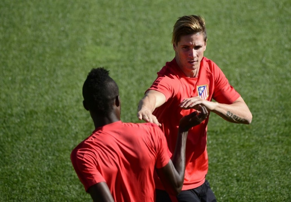 Atletico Madrids Fernando Torres (R) trains with teammate Thomas Partey, at Cerro del Espinos training ground in Majadahonda, on September 29, 2015