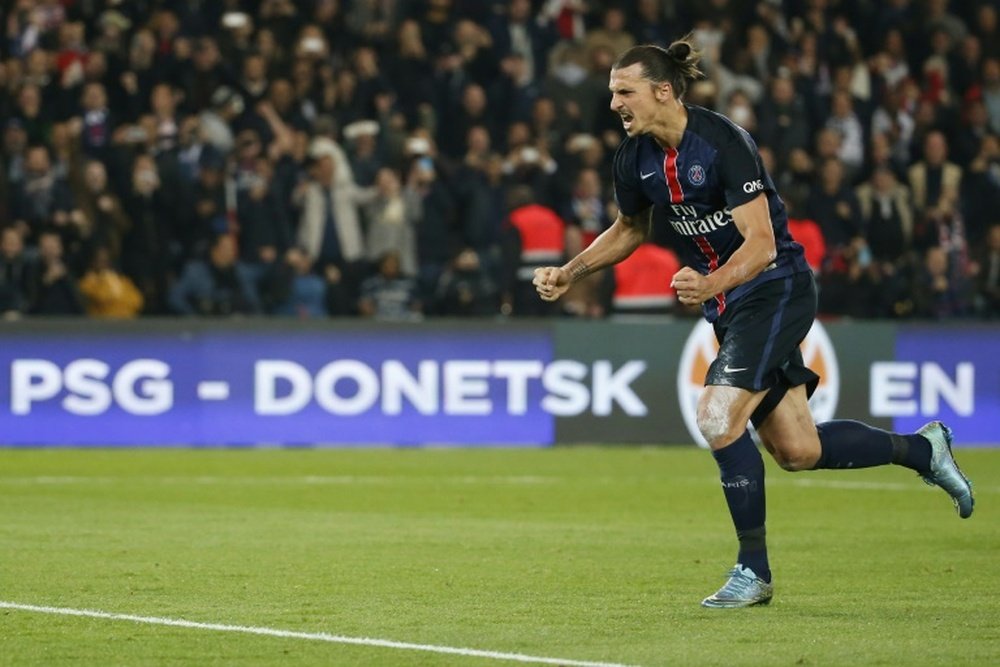 Paris Saint-Germains forward Zlatan Ibrahimovic (C) celebrates after scoring a penatly during a French L1 football match against Marseille on October 4, 2015 at the Parc des Princes stadium in Paris