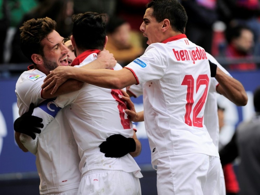 Sevilla players celebrate after their team scored the third goal against Osasuna. AFP