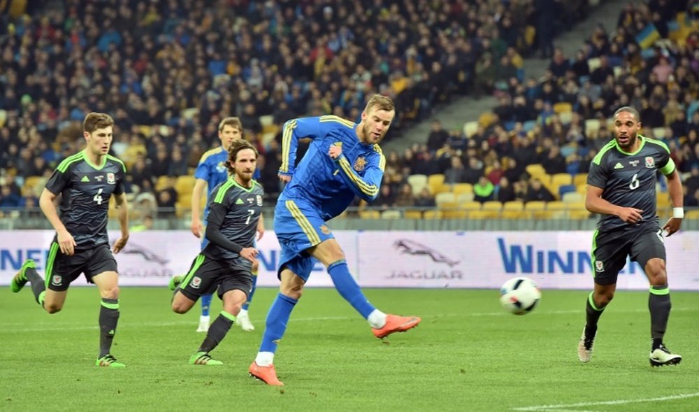 Ukraines Andriy Yarmolenko (C) shoots to score during an international friendly football match against Wales, on March 28, 2016, at Olimpiyskiy stadium in Kiev