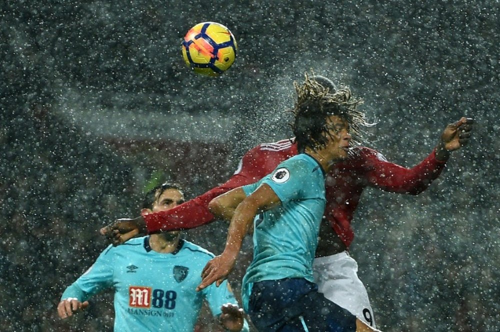 Lukaku challenges Ake in the air at Old Trafford. AFP