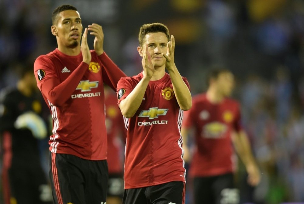 Manchester Uniteds Chris Smalling (L) and Ander Herrera. AFP
