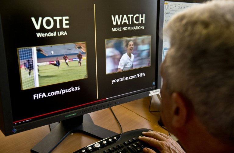 A man looks at a computer screen displaying the FIFA web page where people from around the globe can vote their favorite candidate for the Puskas Award -greatest goal of the year- in Montevideo on December 1, 2015