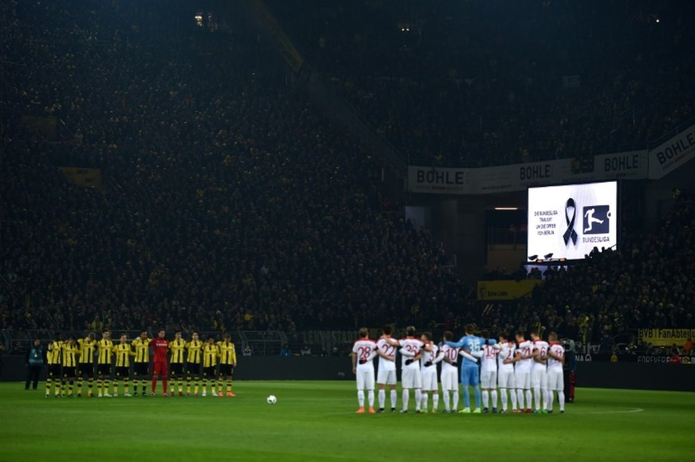 Dortmund and Augsburg players pay tribute to the victims of the recent attacks in Berlin. AFP