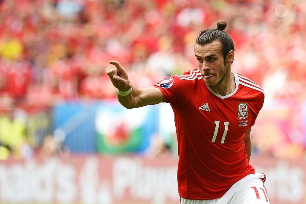 Wales forward Gareth Bale celebrates after scoring the first goal during the Euro 2016 group B football match between Wales and Slovakia at the Stade de Bordeaux in Bordeaux on June 11, 2016