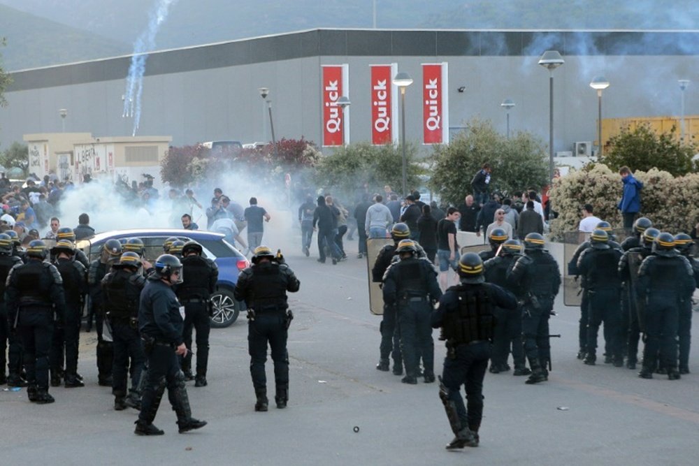 French anti-riot policemen scatter Bastias supporters outside the stadium