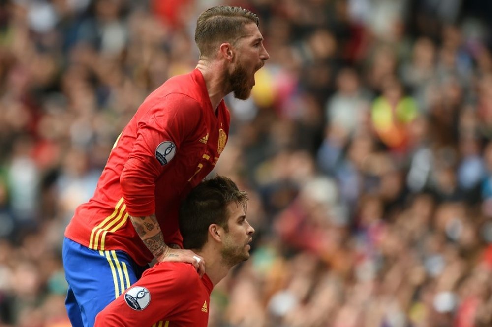 Spain's defenders Gerard Pique and Sergio Ramos celebrate after Pique scored the opening goal during the Euro 2016 match between Spain and Czech Republic on June 13, 2016