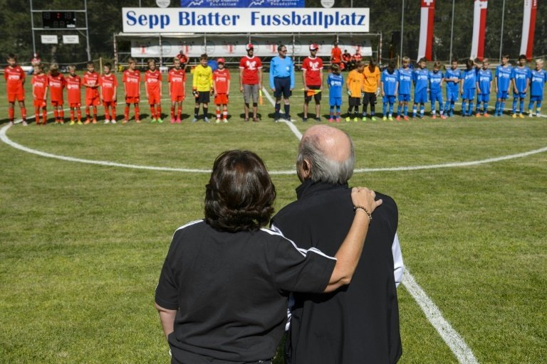 Outgoing FIFA president Sepp Blatter (R) stands next to his daughter Corinne as he encourages junior teams at the opening of the Sepp Blatter Tournament on August 22, 2015 in Ulrichen