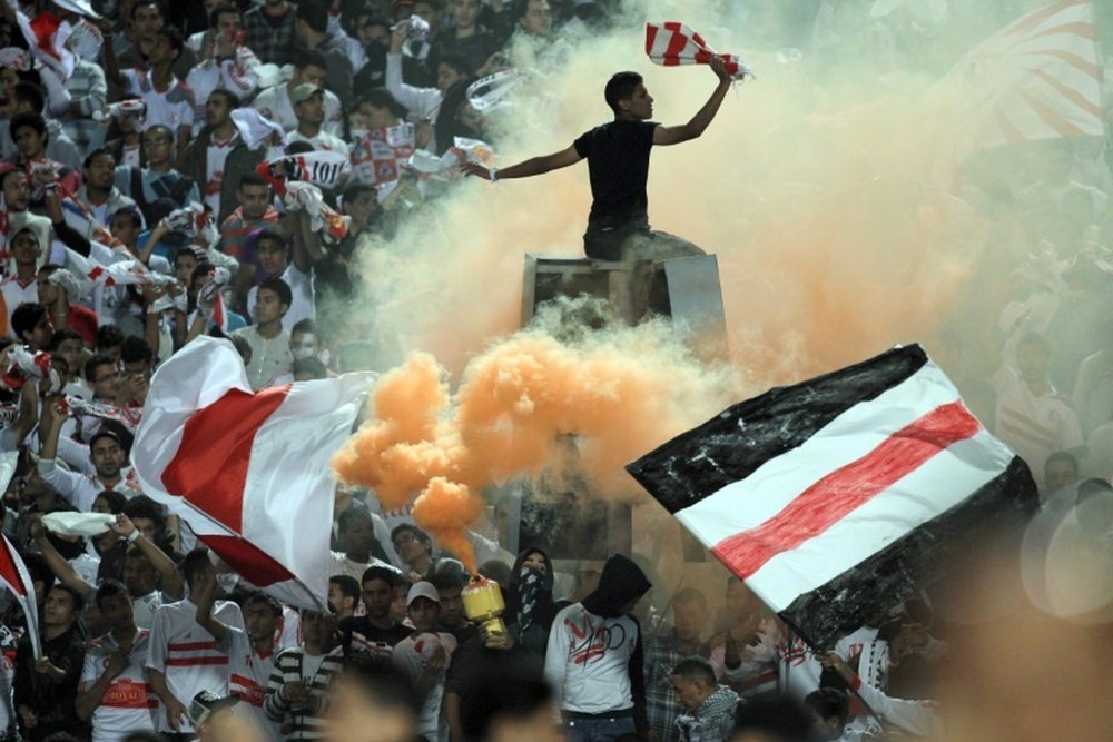 Egyptian fans of Zamalek club celebrate during a match on November 10, 2011