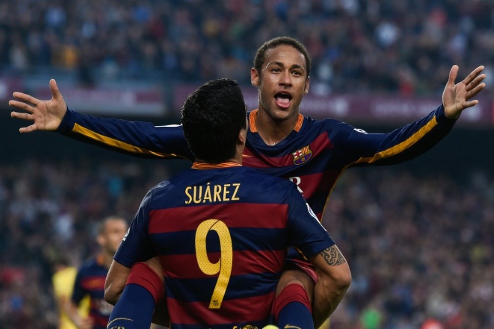 Barcelona forward Neymar (back) is congratulated by teammate Luis Suarez after scoring during the Spanish league match against Villarreal at Camp Nou stadium on November 8, 2015