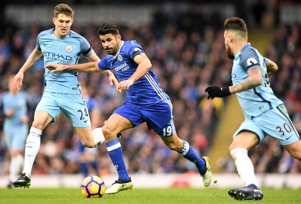 Diego Costa (C) vies with John Stones (L) and Nicolas Otamendi in Chelsea's 3-1 win. AFP