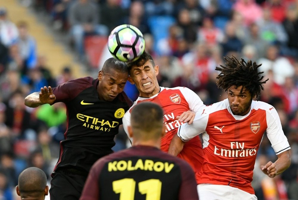 Arsenals defender Gabriel (C) jumps for the ball with Manchester Citys midfielder Fernando (L) during a friendly football match at the Ullevi stadium in Gothenburg on August 7, 2016