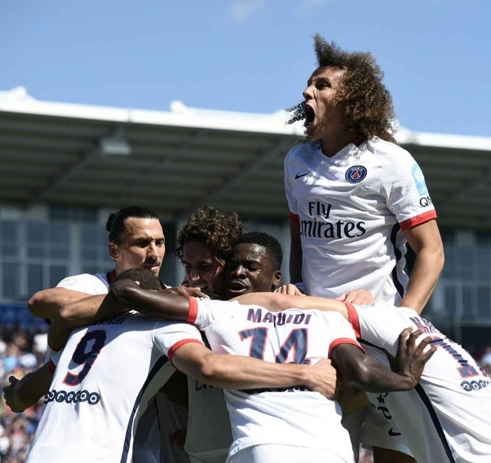 Paris Saint-Germains Uruguayan forward Edinson Cavani is congratulated by teammates during the French Trophy of Champions football match against Lyon at Saputo stadium in Montreal on August 1, 2015
