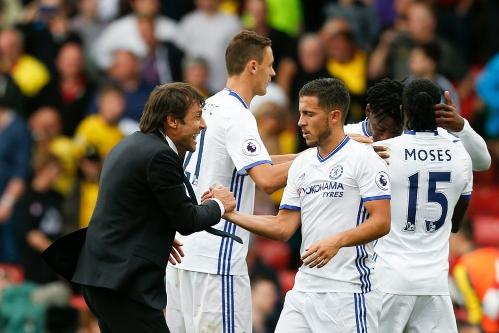 Chelseas manager Antonio Conte (L) shakes hands with midfielder Eden Hazard (C) after the final whistle in their English Premier League match against Watford, at Vicarage Road Stadium in Watford, on August 20, 2016