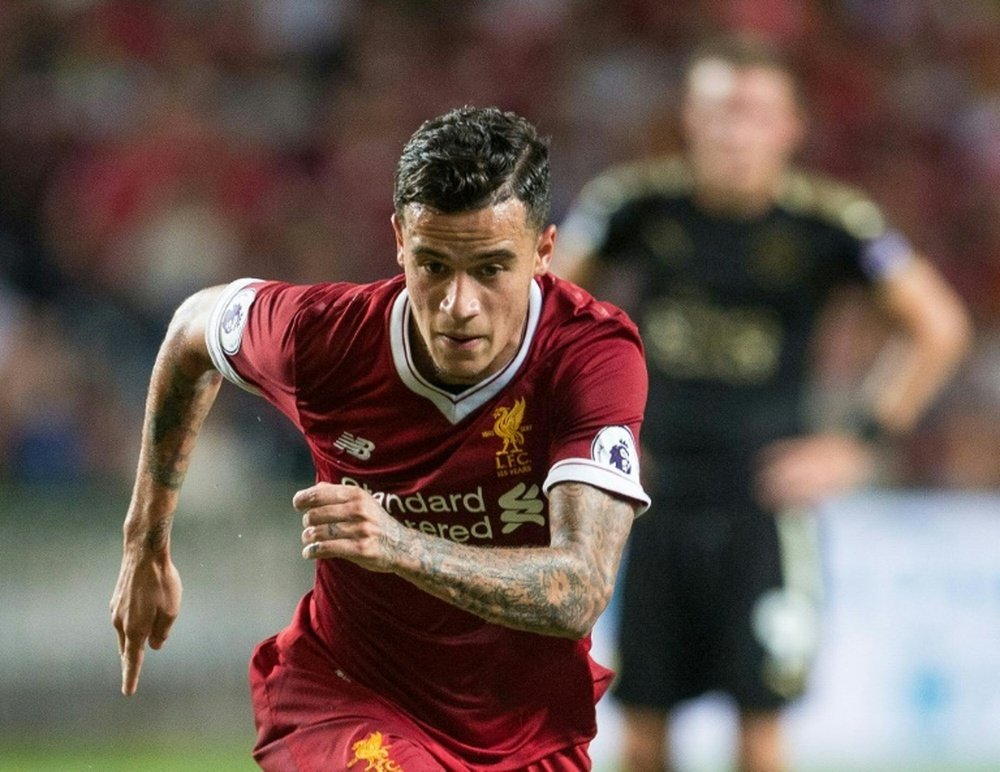 Due to a back injury, Philippe Coutinho will miss the Premier League game against Watford. AFP