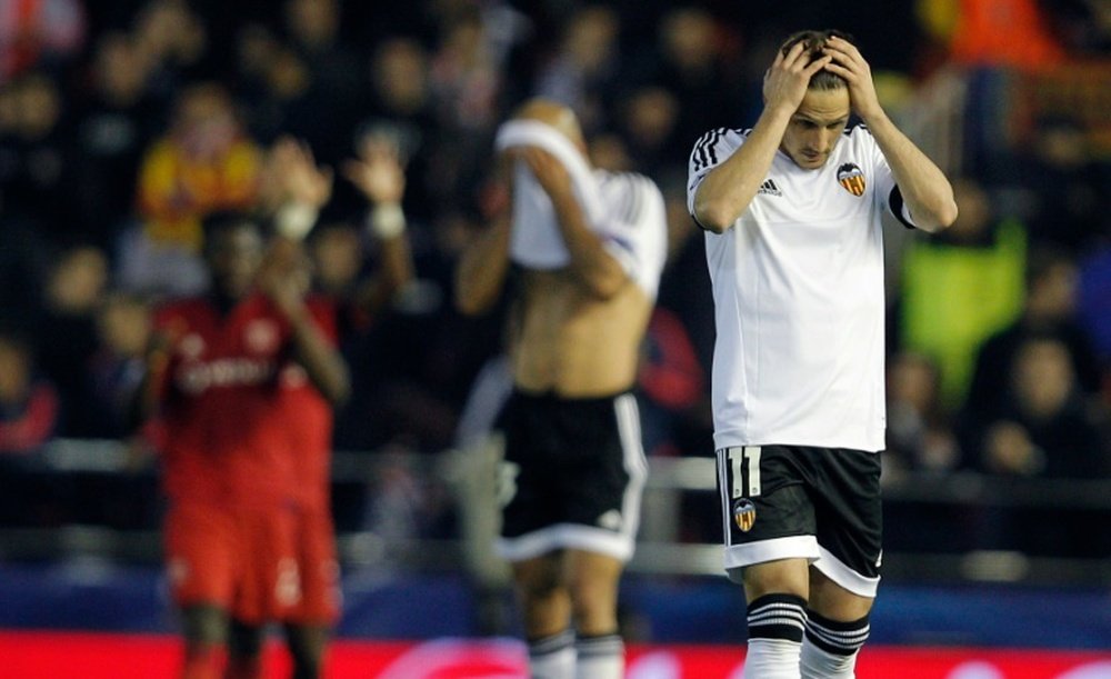 Valencias forward Pablo Piatti reacts after a goal by Lyon during a UEFA Champions League football match on December 9, 2015
