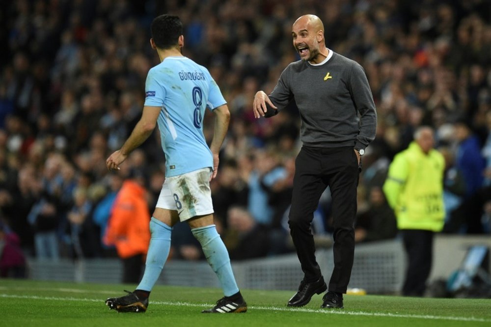 Gundogan (L) is ready to start his second spell at Man City. AFP