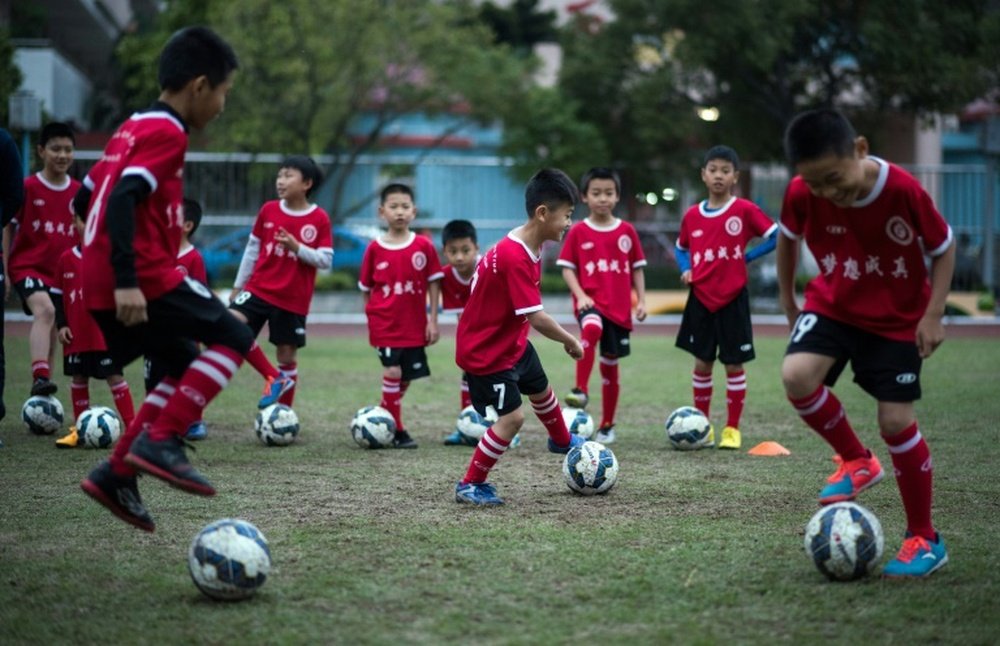 China's president Xi Jinping is optimistic that China can reach the World Cup in about 15 years. AFP