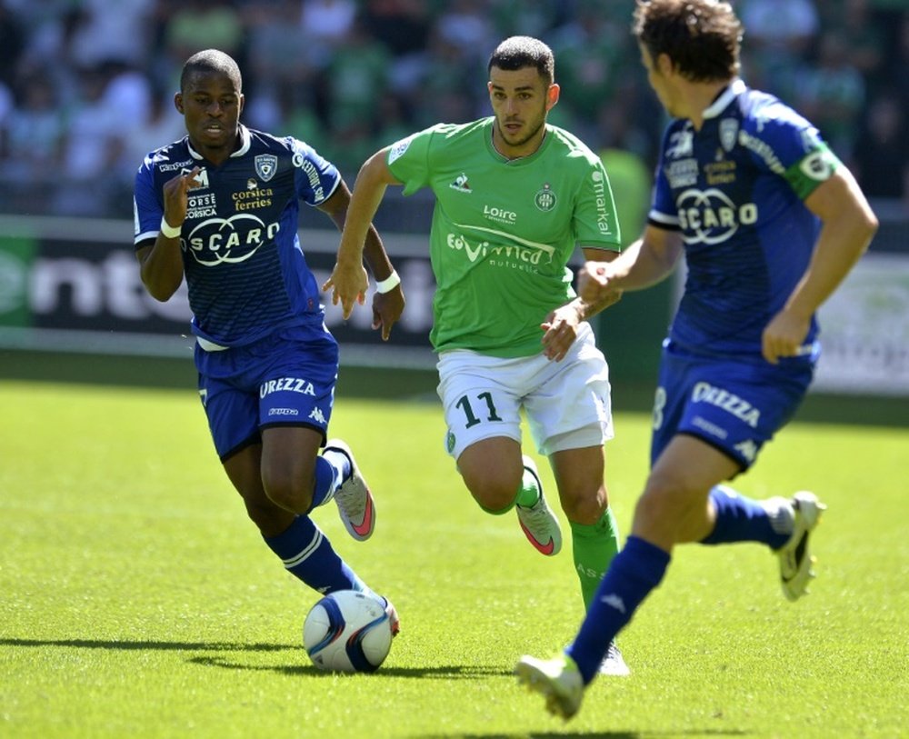 Saint-Etiennes midfielder Valentin Eysseric (C) clashes with Bastias midfielderd Yannick Cahuzac (R) and Floyd Ayite during a French L1 football match on August 30, 2015, at the Geoffroy Guichard Stadium in Saint-Etienne, central France