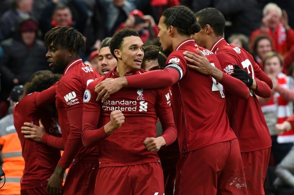 Liverpool celebrate the late goal against Spurs. AFP