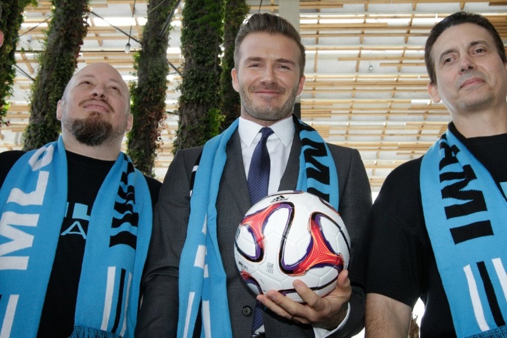 David Beckham poses with fans after holding a press conference at the Perez Art Museum Miami, in Miami, Florida on February 5, 2014