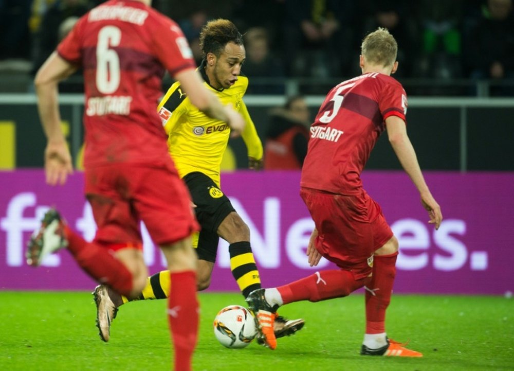 Dortmunds Gabonese striker Pierre-Emerick Aubameyang (C) runs with the ball during the German first division Bundesliga football match Borussia Dortmund vs VfB Stuttgart, in Dortmund, western Germany, on November 29, 2015