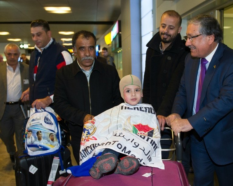 Five-year old Palestinian boy Ahmed Dawabsha (C), who survived a firebombing by Jewish extremists that killed his parents and brother, arrives at Adolfo Suarez Airport near Madrid on March 16, 2016 prior to meeting Real Madrid football stars
