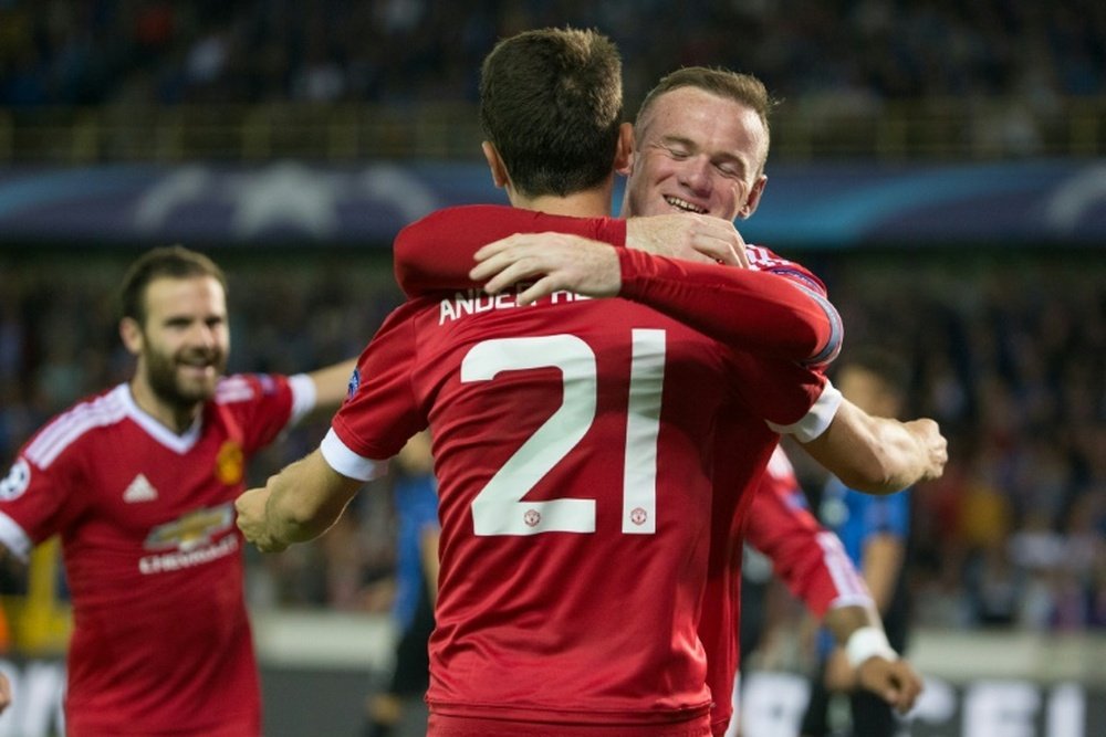 Manchester Uniteds Wayne Rooney (R) celebrates with teammate Ander Herrera after scoring a goal during their UEFA Champions League play-off 2nd round match against Club Brugge, in Brugge, Belgium, on August 26, 2015
