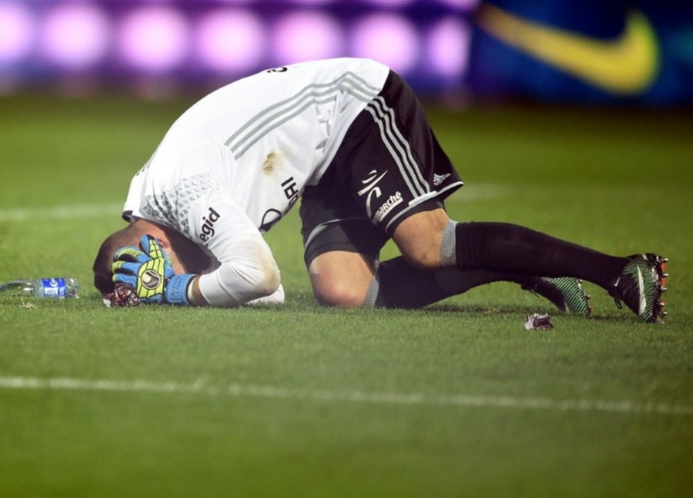 Lyon goalkeeper Anthony Lopes reacting after a firecracker exploded beside him. AFP