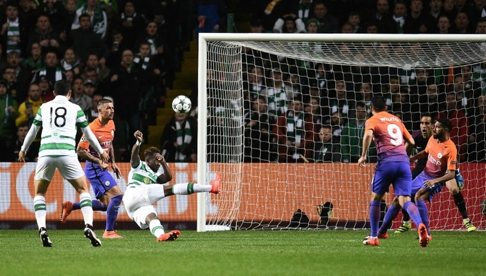 Manchester Citys goalkeeper Claudio Bravo (2R) watches as Celtics striker Moussa Dembele (3L) scores his teams thrid goal during the UEFA Champions League Group C football match between Celtic and Manchester City