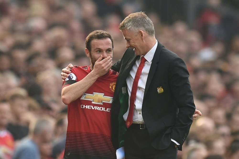 Mata (l) will stay at Man Utd for at least another two seasons. AFP