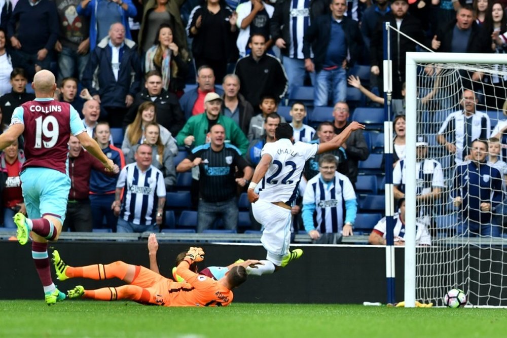 West Bromwich Albions midfielder Nacer Chadli (R) scores their fourth goal during the English Premier League football match between West Bromwich Albion and West Ham United at The Hawthorns stadium on September 17, 2016