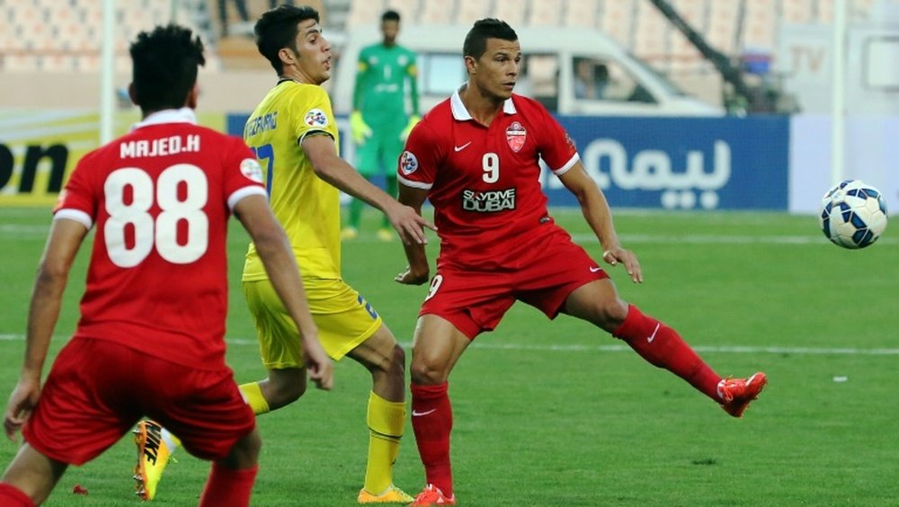 Nafts Iranian midfielder Arash Rezavand (C) vies for the ball with UAEs Al-Ahli player Majed Hassan (L) during their AFC Champions League quarter final football match at the Azadi stadium in Tehran on August 26, 2015