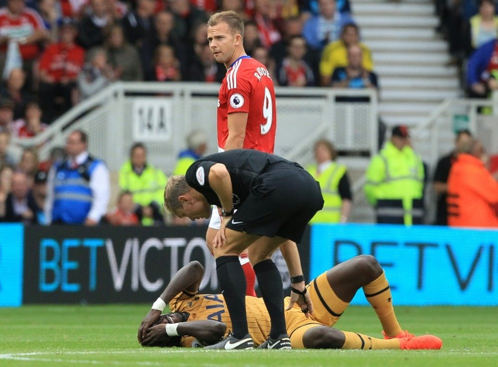 Tottenham Hotspurs French midfielder Moussa Sissoko lays onthe pitch injured during the English Premier League football match between Middlesbrough and Tottenham Hotspur at Riverside Stadium on September 24, 2016