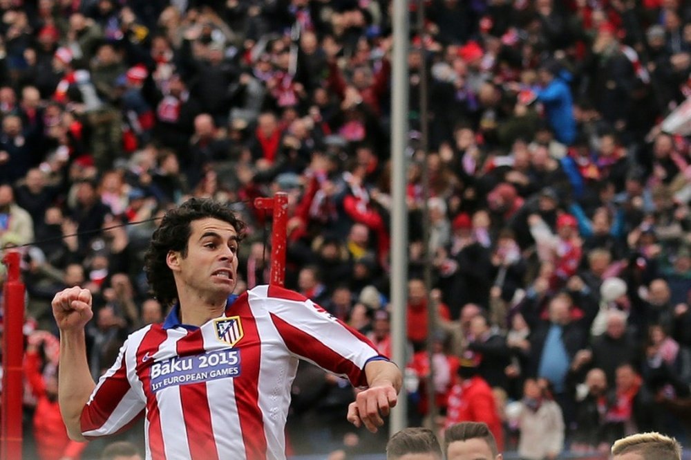 Atletico Madrids Portuguese midfielder Tiago celebrates after scoring during the Spanish league football match Club Atletico de Madrid vs Real Madrid CF at the Vicente Calderon stadium in Madrid on February 7, 2015