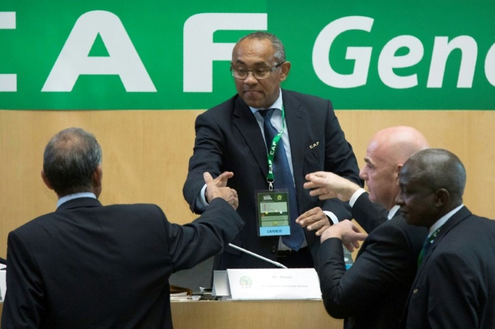 Ahmad Ahmad (C) of Madagascar is congratulated by FIFA president Gianni Infantino.
