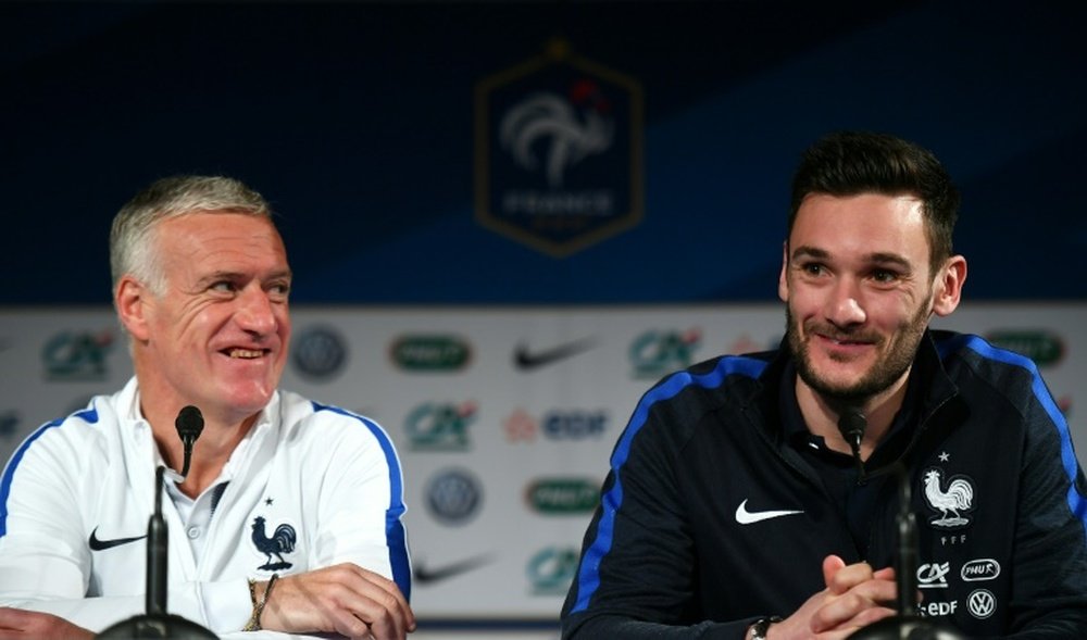 French national football team head coach Didier Deschamps (L) and the teams goalkeeper and captain Hugo Lloris give a press conference at the Stade de France stadium on March 28, 2016