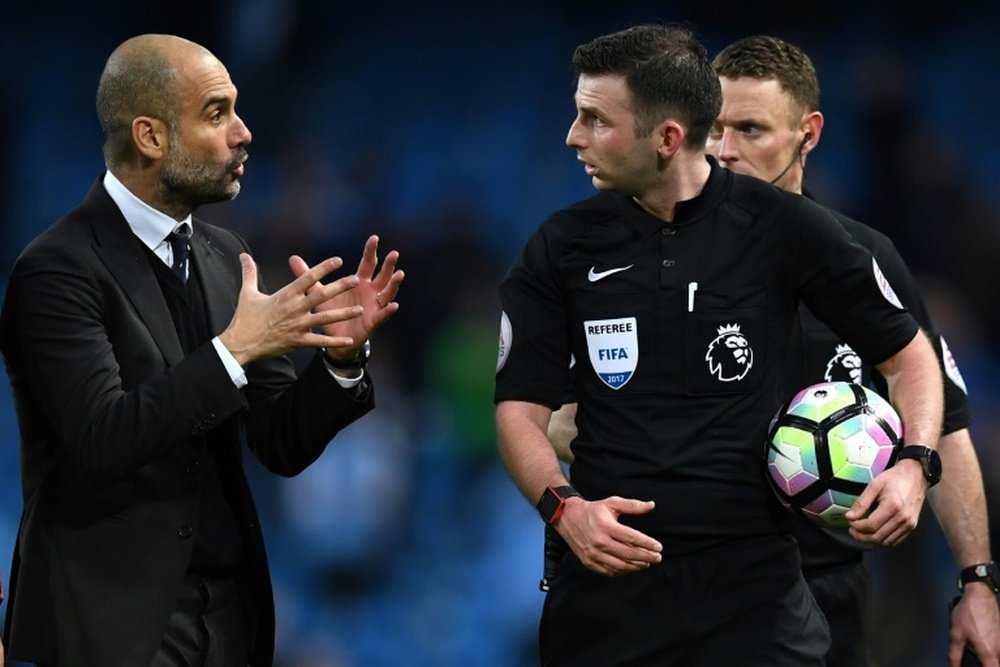 Manchester Citys manager Pep Guardiola (L) speaks with referee Michael Oliver after the English Prem
