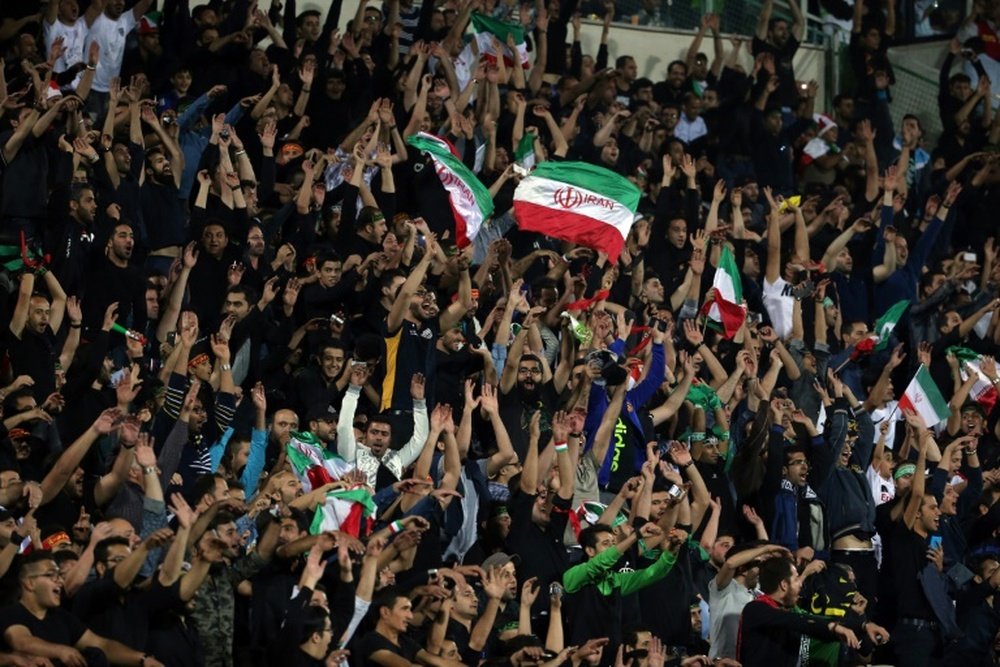 Irans supporters celerbate their opening goal during the 2018 World Cup qualifying football match between Iran and South Korea at the Azadi Stadium in Tehran on October 11, 2016