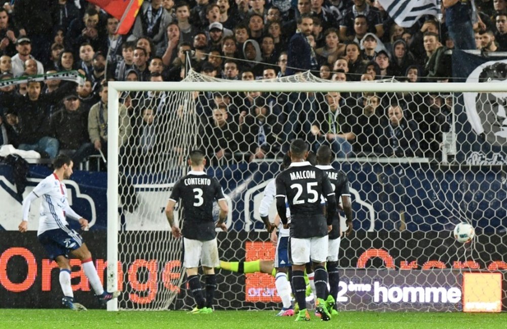 Lyons Emanuel Mammana (L) scores a late goal during their match against Bordeaux
