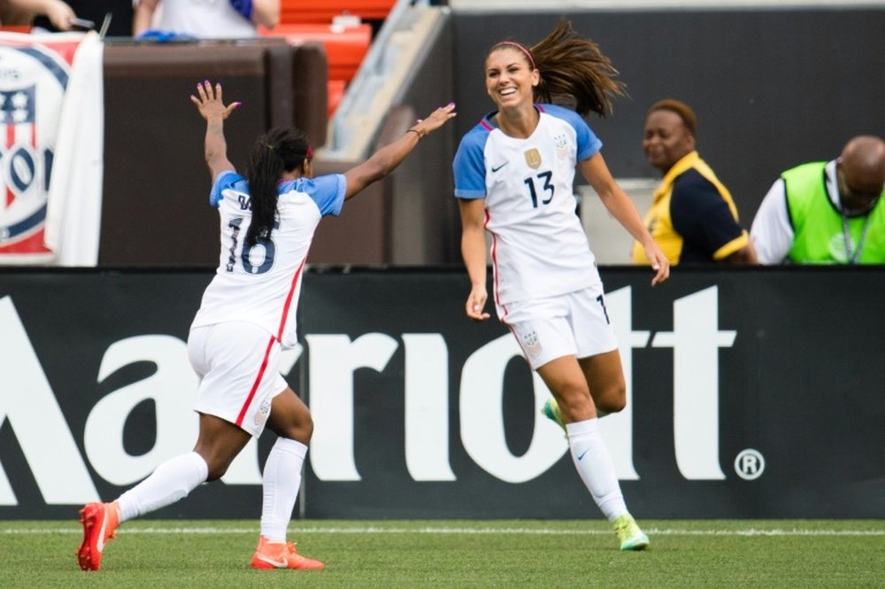 Crystal Dunn (L) celebrates with Alex Morgan after Morgan of the US Womens National Team scored during the second half of a friendly match against Japan on June 5, 2016 in Cleveland, Ohio